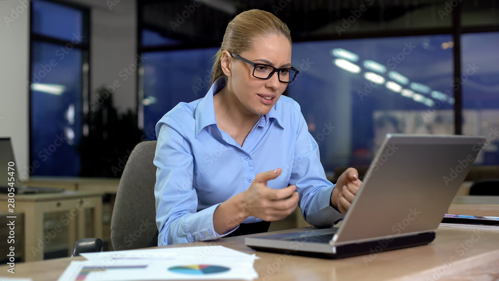 Businesswoman irritated using stuck laptop, mad about data loss, software error Businesswoman irritated using stuck laptop, mad about data loss, software error