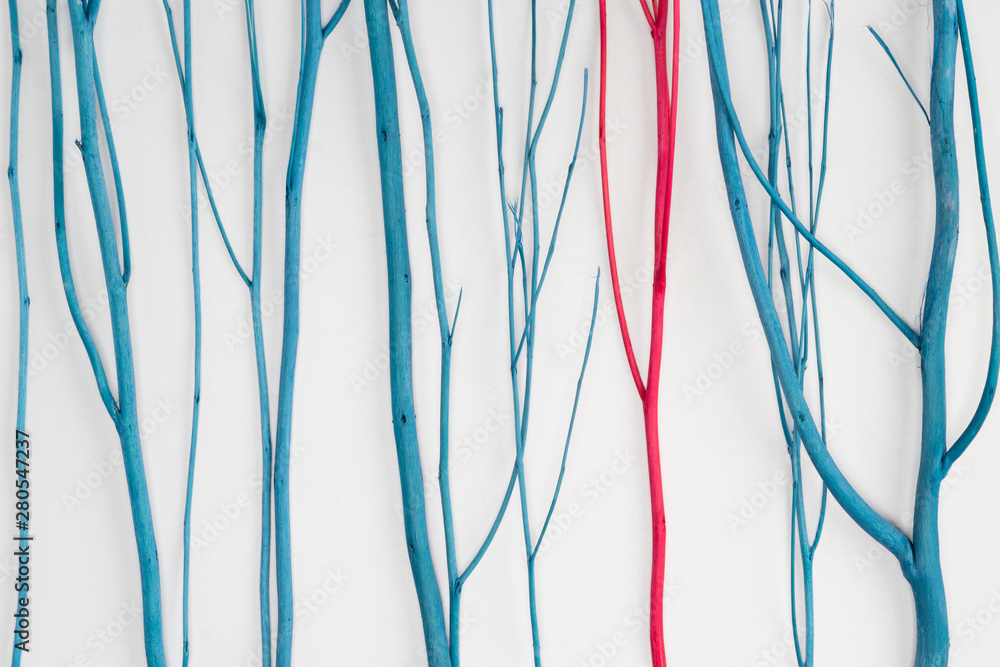 Blue branches and one red on white background. Stand out, original concept. Close-up, front view Blue branches and one red on white background. Stand out, original concept. Close-up, front view