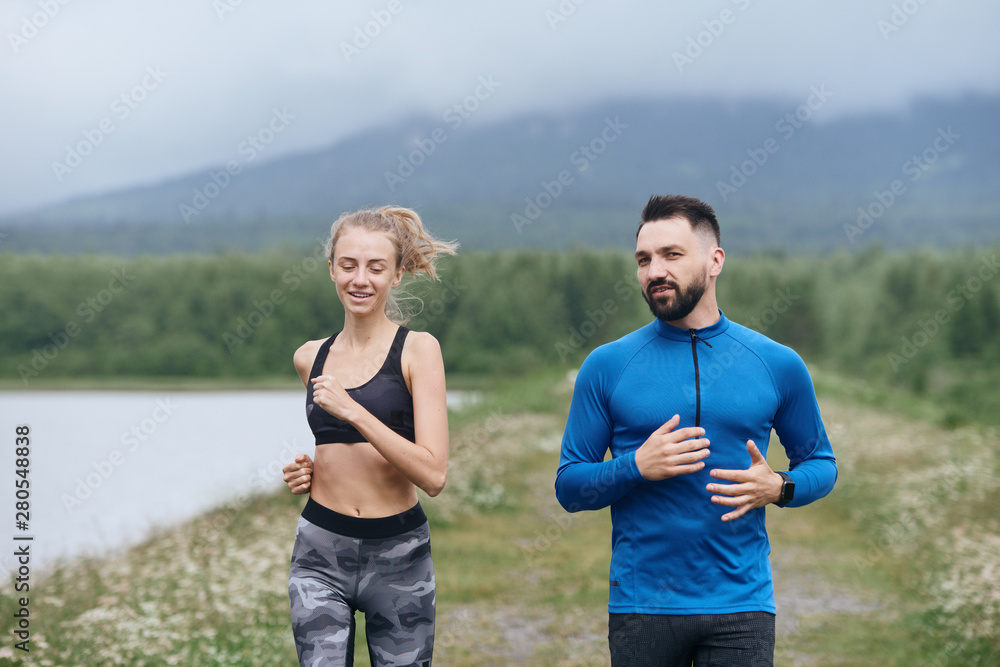 Trainer and female sportsman jogging outdoor Trainer and female sportsman jogging outdoor