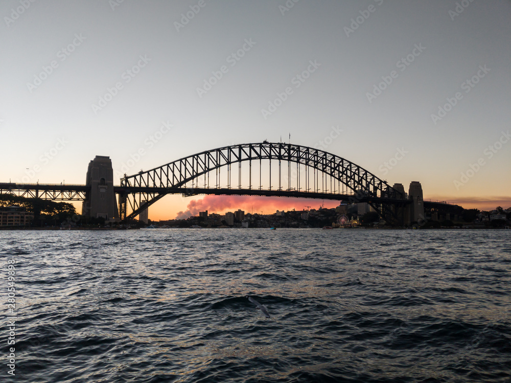 Silhouetted view of Sydney Harbour Bridge at sunset, Australia