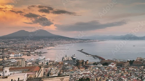 Naples, Italy. Top View Skyline Cityscape In Evening Lighting. Tyrrhenian Sea And Landscape With Volcano Mount Vesuvius. City During Sunset And Night Illuminations. Day To Night Transition photo