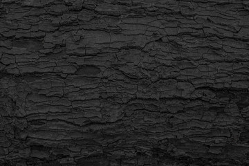 Fototapete Brennholz Textur Gebrannter hölzerner Beschaffenheitshintergrund. Raue schwarze Holzoberfläche durch brennendes Feuer. Dunkles Material aus Kohle oder Holzkohle.  © Lemonsoup14