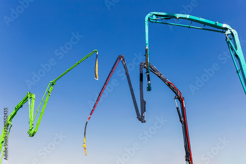 Sleeves for pouring concrete against the blue sky. Concrete pump for construction works.