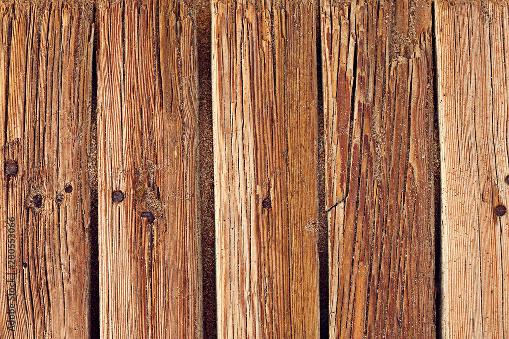 Boards of a wooden walkway lying on the sand Boards of a wooden walkway lying on the sand