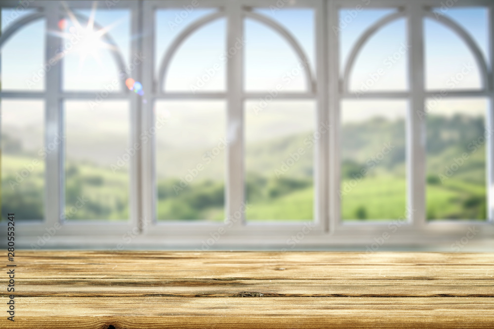 Table background and spring time. Green garden in blurred view outside the window. Empty space for decoration and an advertising product. Table background and spring time. Green garden in blurred view outside the window. Empty space for decoration and an advertising product.