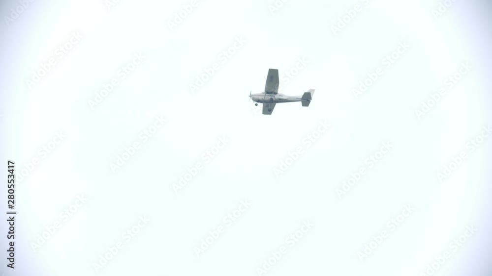 A white airplane flying in the white sky A white airplane flying in the white sky