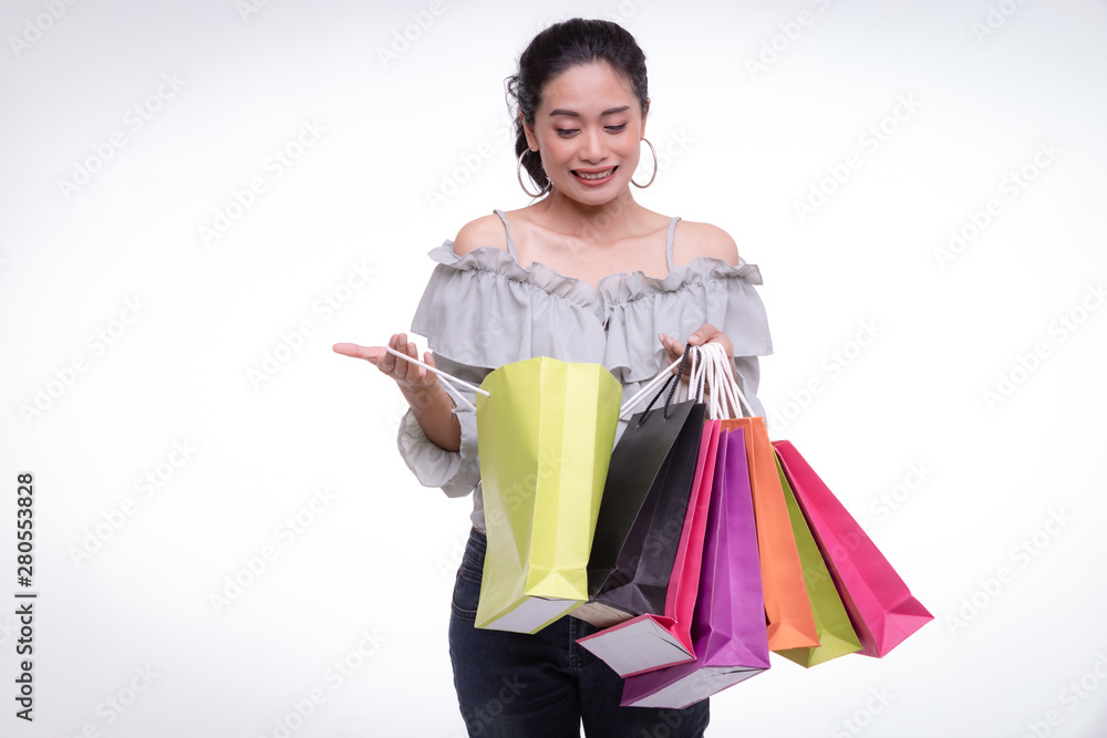 Asian woman carry colorful paper bags..