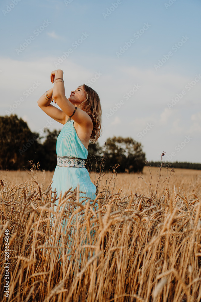 Beautiful Young Woman Dancing In The Field at sunset Beautiful Young Woman Dancing In The Field at sunset