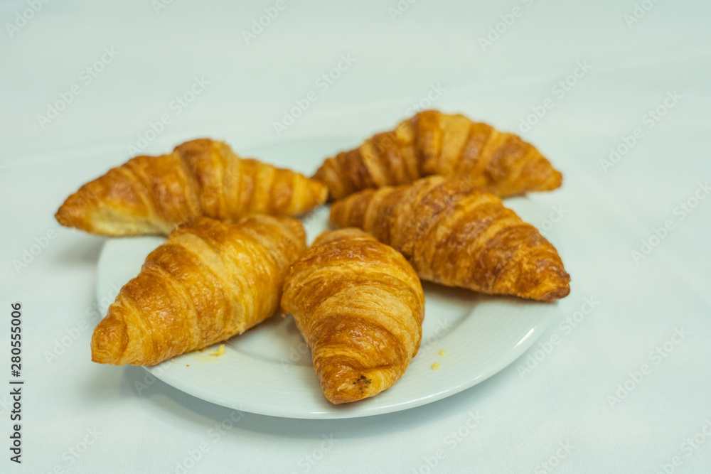 Isolated plate of puffy croissant on white plate for breakfast