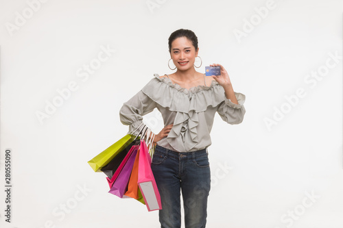 Asian woman carry colorful paper bags..