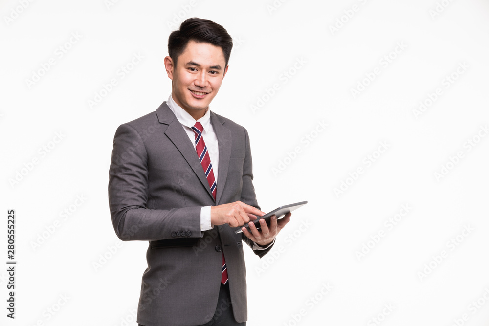 Businessman standing and using tablet computer..