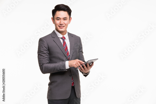 Businessman standing and using tablet computer..