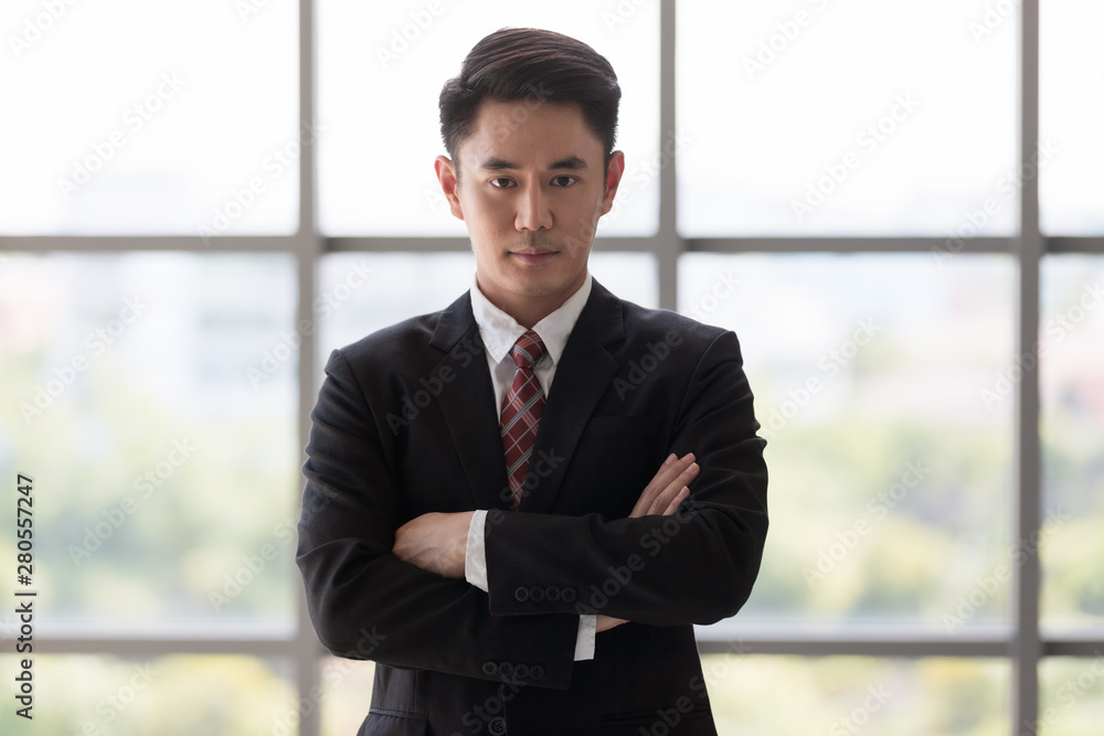 Businessman standing and crossed his arm..