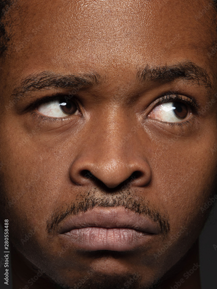Obraz premium Close up portrait of young and emotional african-american man. Highly detail photoshot of male model with well-kept skin and bright facial expression. Concept of human emotions. Thoughtful.