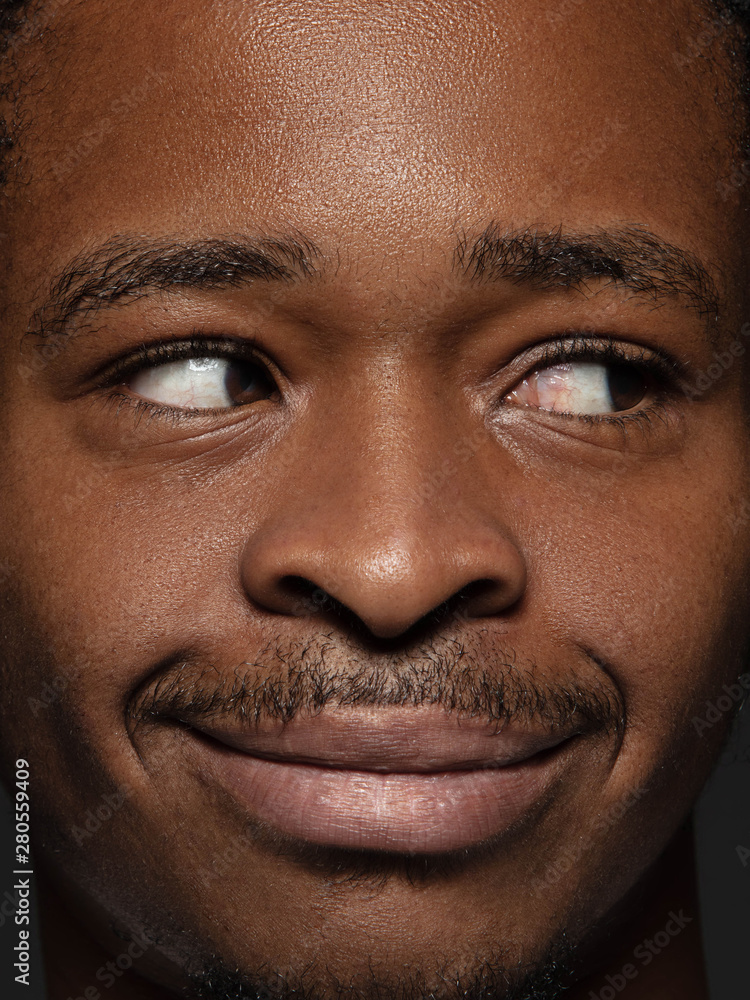 Obraz premium Close up portrait of young and emotional african-american man. Highly detail photoshot of male model with well-kept skin and bright facial expression. Concept of human emotions. Looking at side.