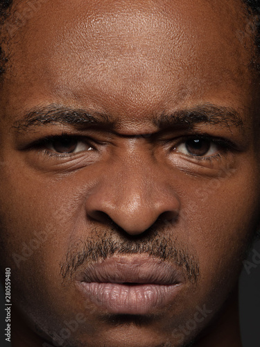 Close up portrait of young and emotional african-american man. Highly detail photoshot of male model with well-kept skin and bright facial expression. Concept of human emotions. Outraged.