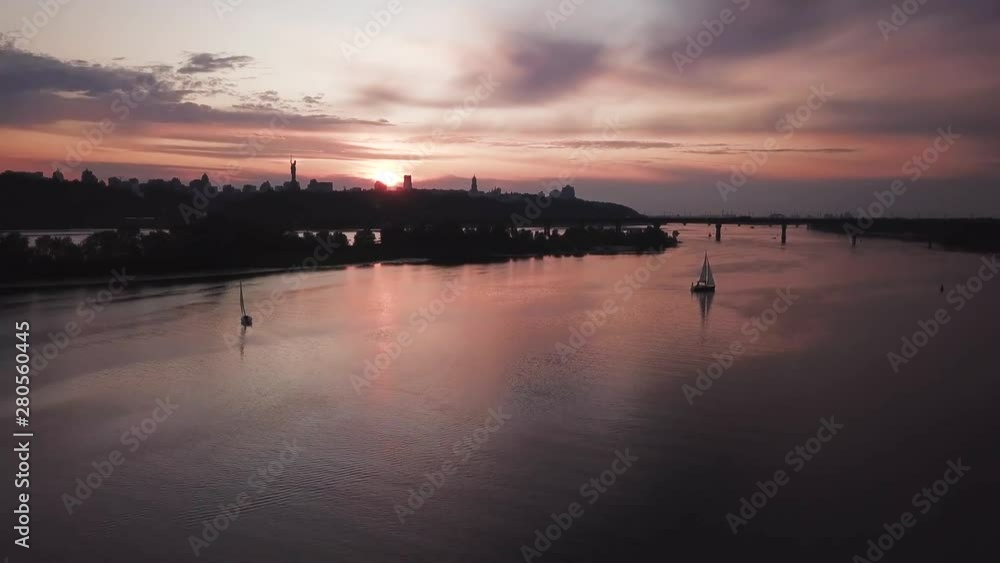 aerial city view, yacht on sunset. Drone shot,bird's eye aerial city view, yacht on sunset. Drone shot,bird's eye