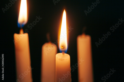 the light of the candle illuminates the darkness