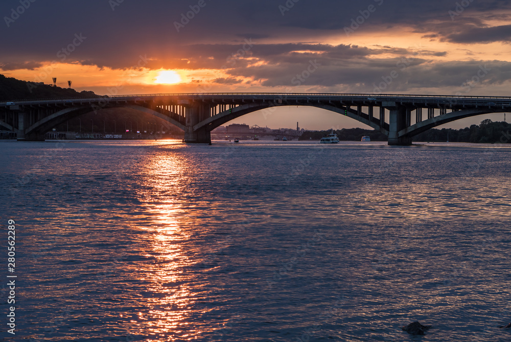 Scenic sunset view on a metro bridge and Dneper River from Hydropark in Kyiv, Ukraine