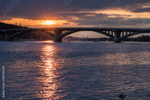 Scenic sunset view on a metro bridge and Dneper River from Hydropark in Kyiv, Ukraine