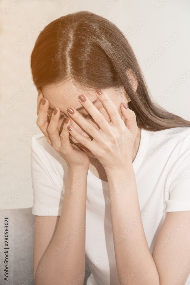 Asian woman with severe migraine headache holding hands to head on white background.. Asian woman with severe migraine headache holding hands to head on white background..