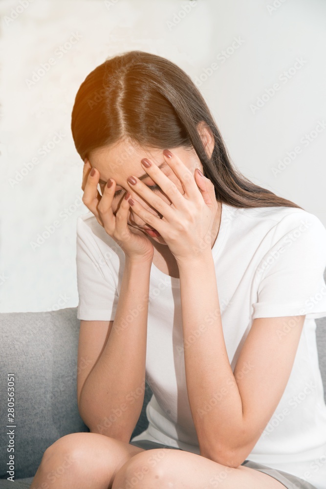 Asian woman with severe migraine headache holding hands to head on white background.. Asian woman with severe migraine headache holding hands to head on white background..