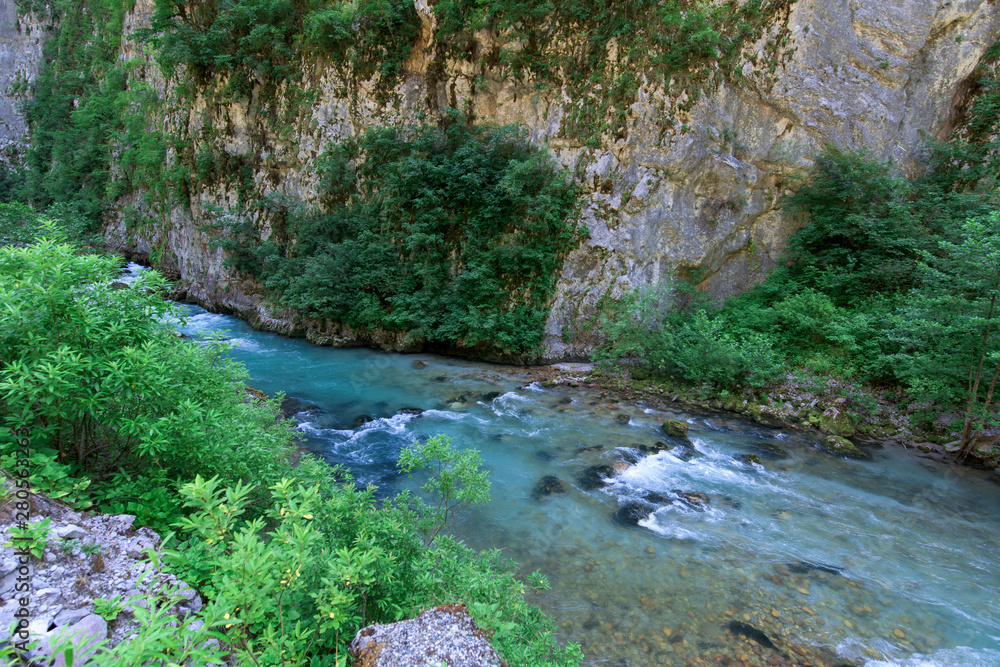 mountain river between sheer cliffs . blue clear water of the river. mountain river between sheer cliffs . blue clear water of the river.
