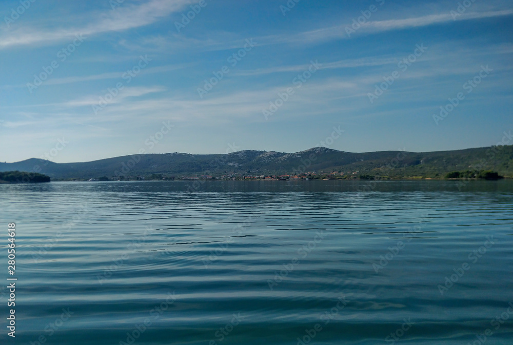 Wonderful calm blue adriatic sea shot from moving sailing boat.