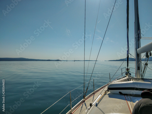 Wonderful calm blue adriatic sea shot from moving sailing boat.