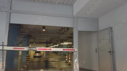 Car entering gated underground parking of a residential - office building