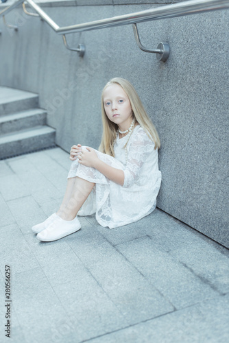 a gentle young albino girl with smooth and even hair, pale white skin and tender lips. blue eyes the location of the city. white lace dress white beads