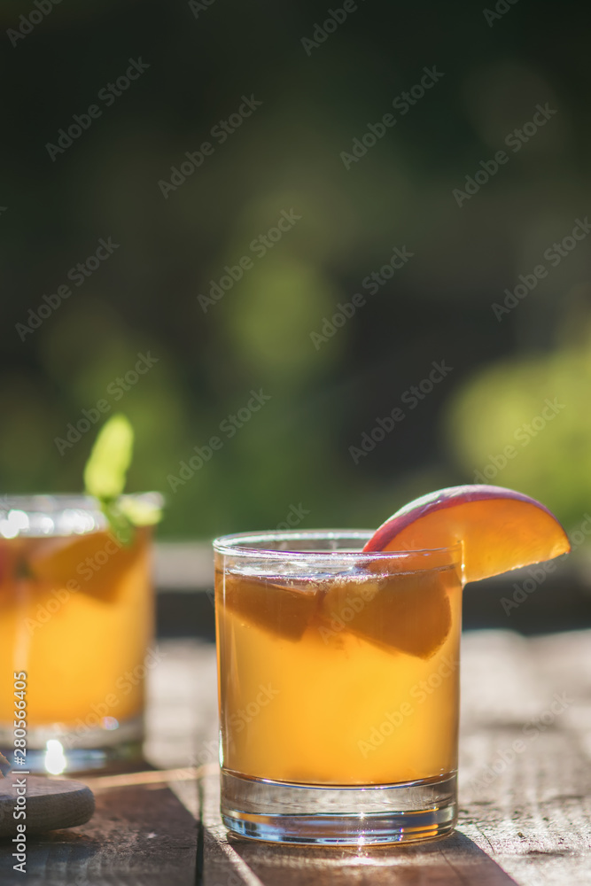 Homemade Fermented Raw Kombucha Tea Ready to Drink With peach. Summer probiotic healthy beverage in glass. Homemade Fermented Raw Kombucha Tea Ready to Drink With peach. Summer probiotic healthy beverage in glass.