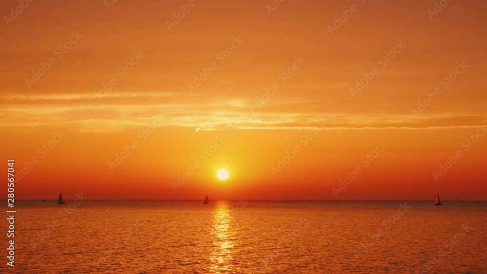 Beautiful sunset over Lake Ontario in the USA, yachts are visible in the distance Beautiful sunset over Lake Ontario in the USA, yachts are visible in the distance