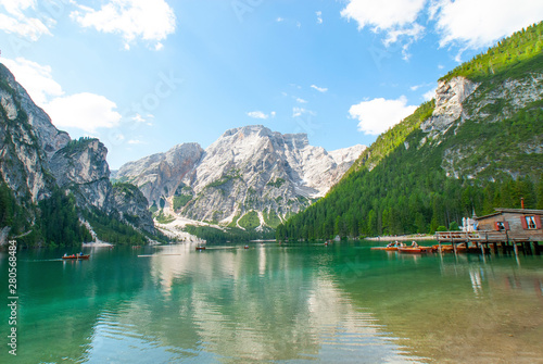 Turquoise water of the lake Lago di Braies, Pragser Wildsee surrounded by pine forest and mountains in the Prags Dolomites in South Tyrol, Italy, Europe