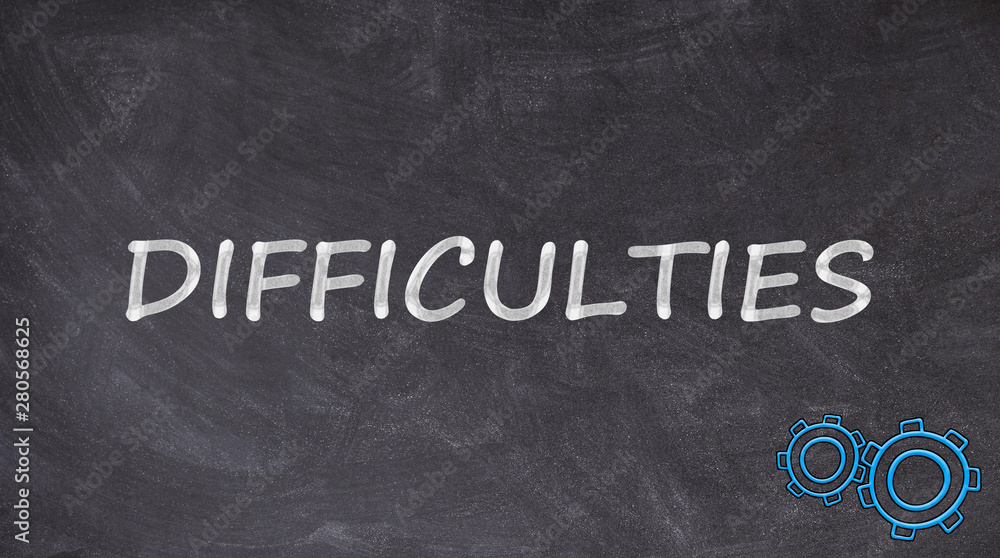 Fototapeta premium Difficulties written on blackboard with rotating toothed wheels