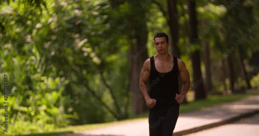 Man running Slow Motion in Park sunny day. Sportsman Runner Athlete training Man running Slow Motion in Park sunny day. Sportsman Runner Athlete training
