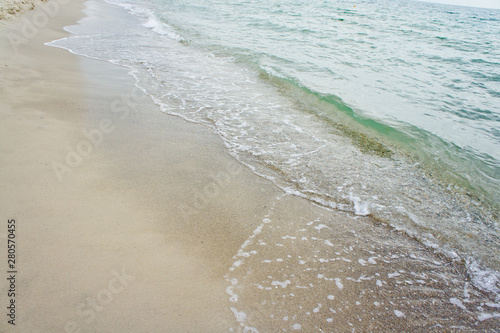 Sea wave on the clean sandy shore of the Black Sea