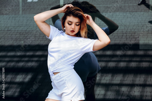 Stylish girl in white t-shirt and white shorts. © Anhelina
