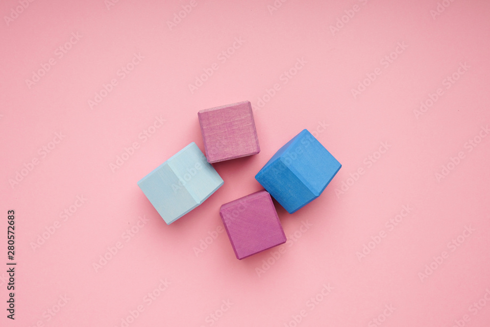 Colorful wooden cubes on pink background.Creativity toys. Children's building blocks Colorful wooden cubes on pink background.Creativity toys. Children's building blocks