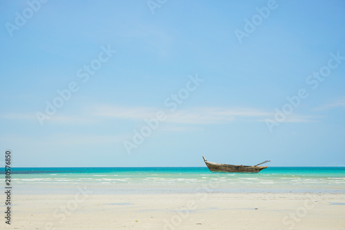 canoe on the beach with blue sky