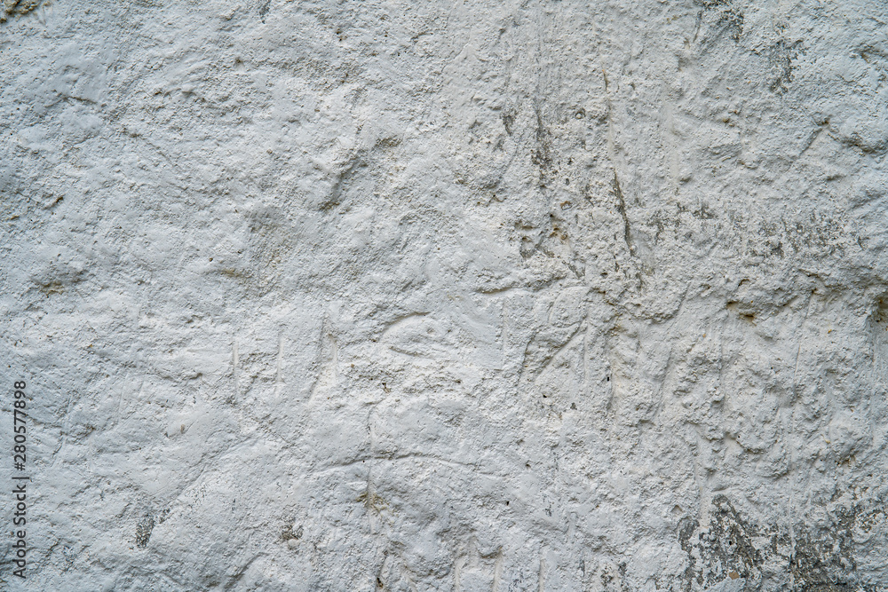 Fototapeta premium White natural chalk rock wall. Grunge gray and white background texture, close up