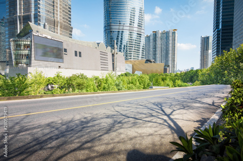 empty, modern square and skyscrapers under sunbeam