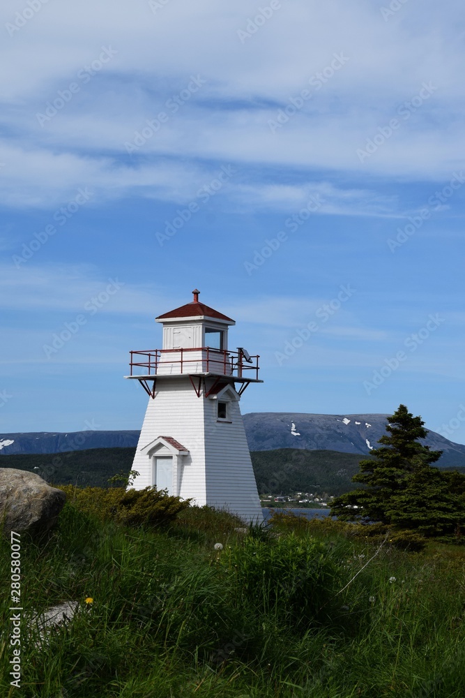 closeup of the red and white lighthouse in Woody Point, Gros Morne National Park Newfoundland and Labrador Canada