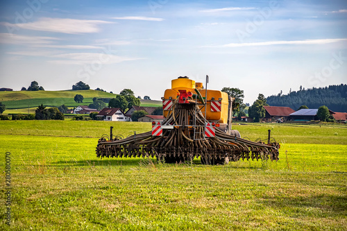 Application of manure on arable farmland with the heavy tractor works at the field in Germany