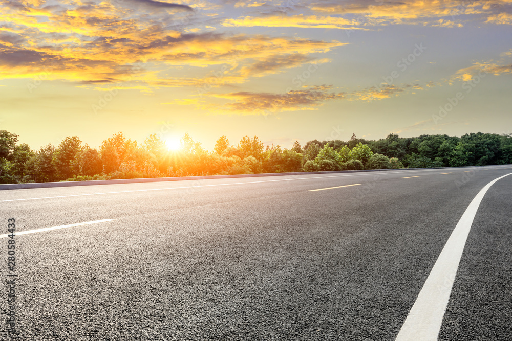 Asphalt highway and green forest with beautiful cloud landscape at sunset Asphalt highway and green forest with beautiful cloud landscape at sunset