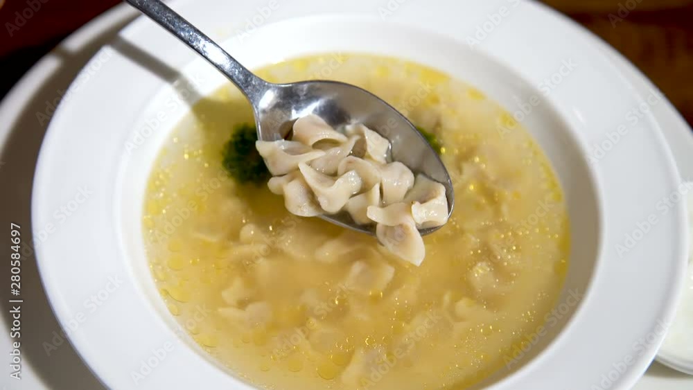 Small dumplings scooped into a spoon. Asian cuisine. Exotic Food.