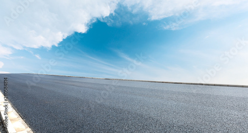 Asphalt road and blue sky with white clouds landscape