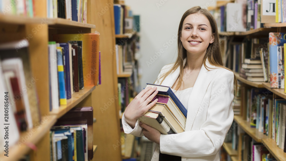 Back to school concept with woman studying in library Back to school concept with woman studying in library