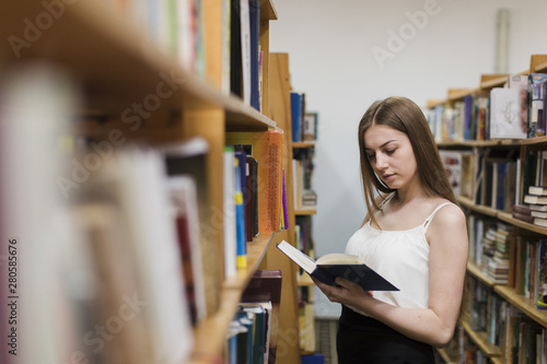 Back to school concept with woman studying in library