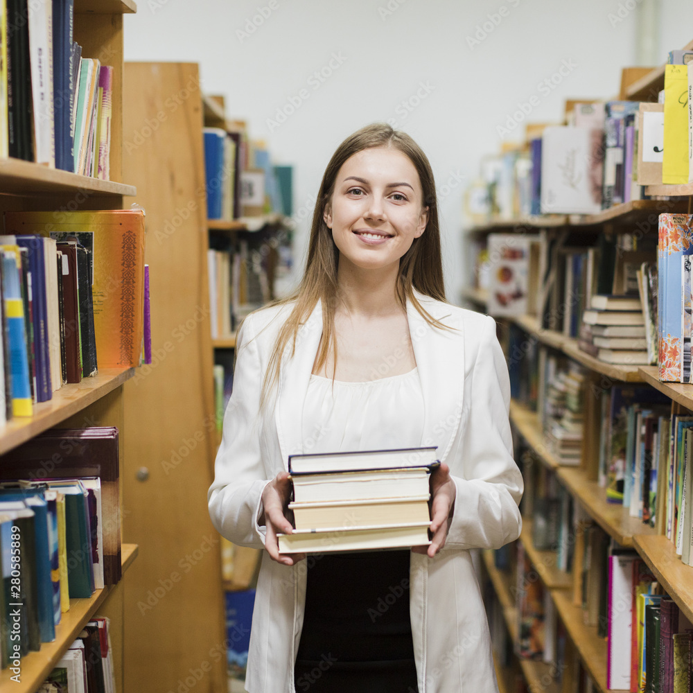 Back to school concept with woman studying in library Back to school concept with woman studying in library